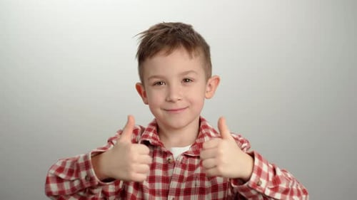 Smiling Boy Giving Two Thumbs Up Gesture