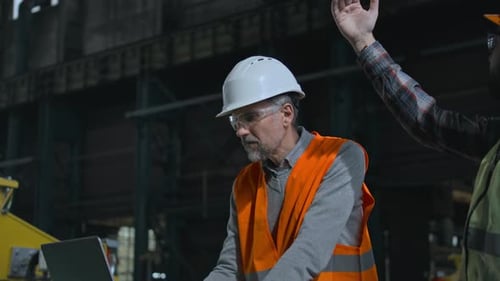Professional Engineer Uses Laptop Male Worker Manages Industrial Equipment