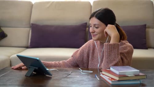 Woman Video Conferencing with a Tablet Indoors