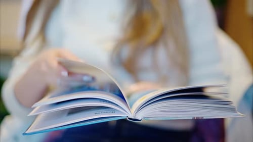 Woman reading a book at a coffee shop close up