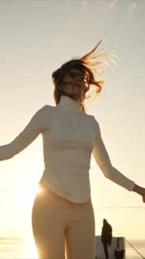 Young Woman Jumping Rope at Sunrise By the Sea