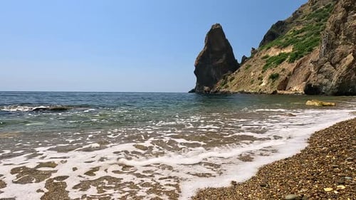 Small Sea Wave Blurred Soft Foamy Waves Washing Golden Sandy Beach and Volcanic Rocky Shores Nobody