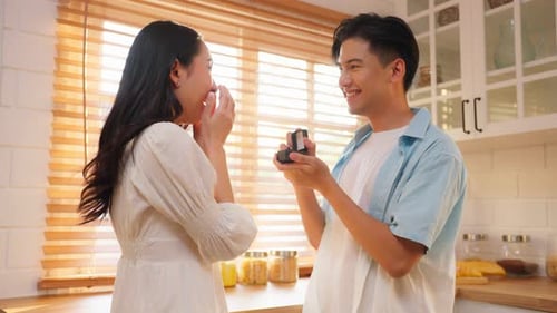 Couple Engaged in Sunlit Kitchen, Romantic Moment