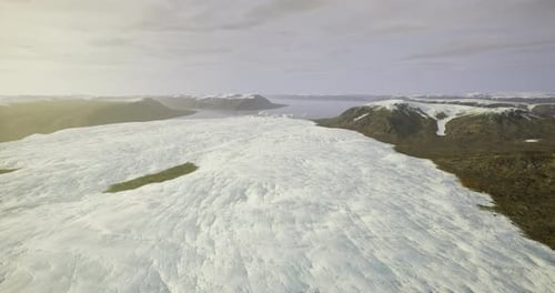 Vast Ice Expanse Stretches Across Dramatic Mountain Landscape in Remote Area
