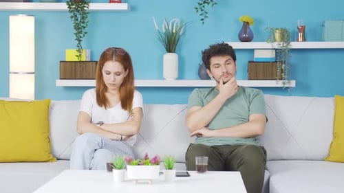 The couple is sad and unhappy at home.