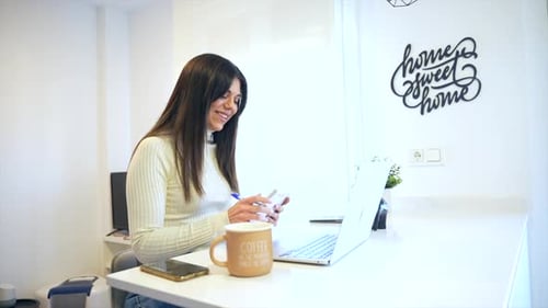 Businesswoman working with a computer smiling, business, home office, telecommuting