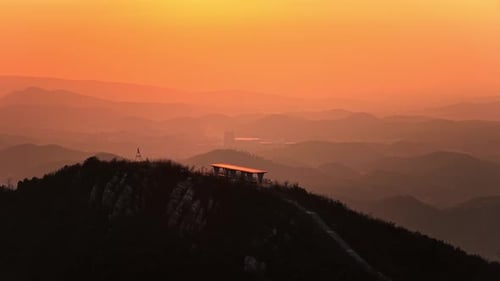Scenic Mountain Vista at Sunset with Orange Sky