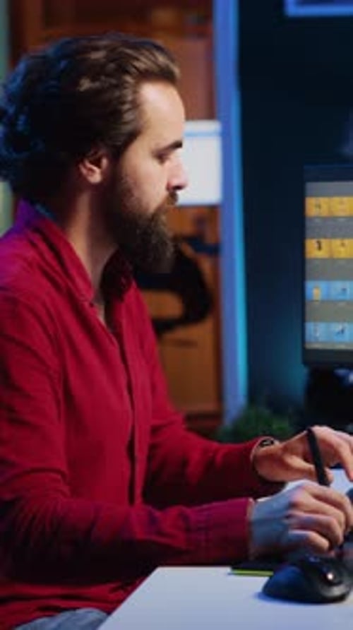 Man Works with Pen Tablet at Night