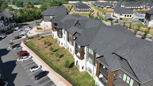 Aerial view of suburban apartment complex on sunny day