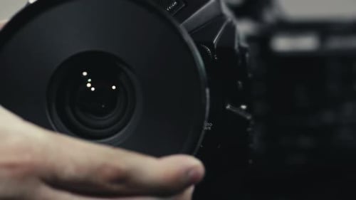Shot of a Blackmagic Ursa Mini Pro 4.6K cinema camera with a compact prime lens. A Person is removin