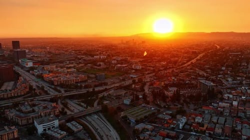 Sun sets behind the mountain range in Los Angeles, California, USA.