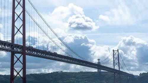 Timelapse of the 25th of April Bridge in Lisbon, Portugal. Close up of the bridge on a cloudy day a