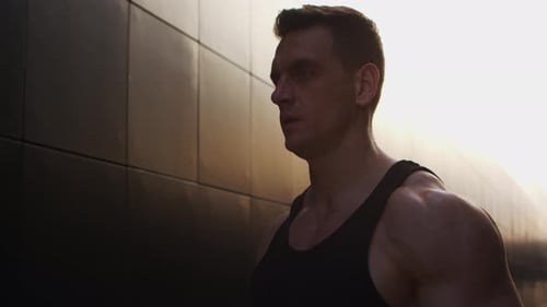 Muscular Man Exercising Arms with Resistance Bands