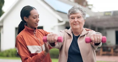 Senior Woman Exercising with Trainer at Home