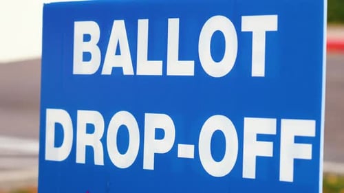 Blue Ellection Ballot Drop-off Sign Blowing in the Wind Outside Close Up