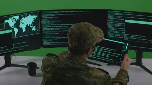 Man Soldier Working With Tablet While Write Code With Multiple Computer Screens In Green Screen
