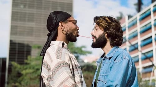 Gay Couple Playing with Candy in the Street