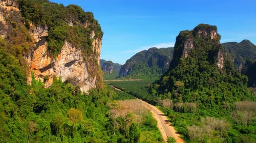 Aerial View of Tropical Mountains and Winding Road