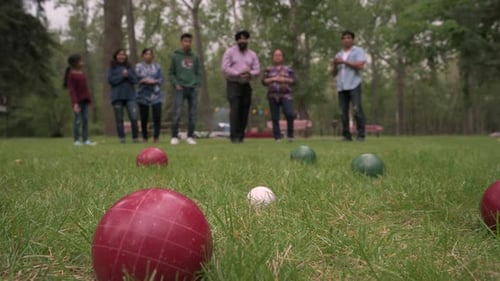 Indian Family Playing Boules In Park