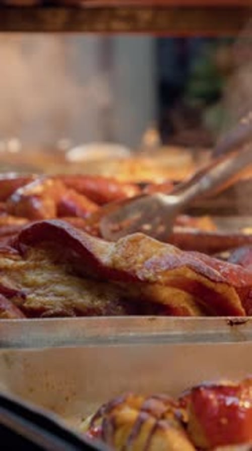 Vertical video Street food vendor serving hot grilled meat and vegetables