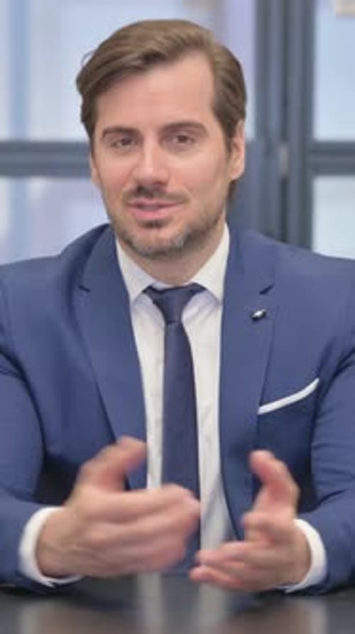 Talking Young Businessman Doing Video Chat in Office, vertical video