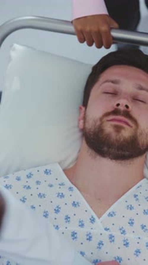 Unconscious Tired Infected Man Inside the Hospital Corridor Hurrying Busy Doctors Caring for Patient