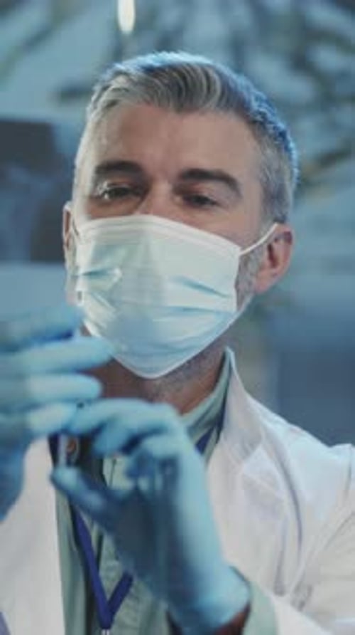 Medical Professional Preparing Injection in Gloved Hand