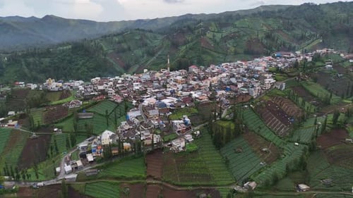 Aerial drone view of a small village town city in the rural hills mountains of east java indonesia