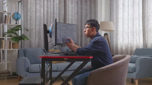Asian Boy Programmer Using Smartphone While Creating Software Engineer Developing App, Program