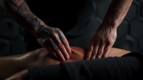 Woman Receiving a Leg Massage in Dimly Lit Room