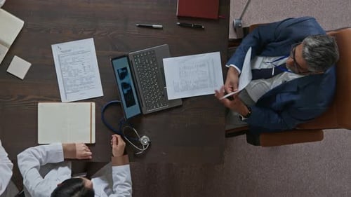 Medical Clinic Executive Arguing with Doctor about Patient Treatment at Meeting