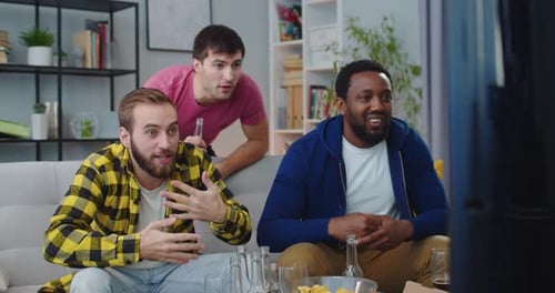 Three Friends Celebrate While Watching Television Together