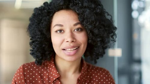 Webcam view. African american female teacher talking on video call looking at camera sitting