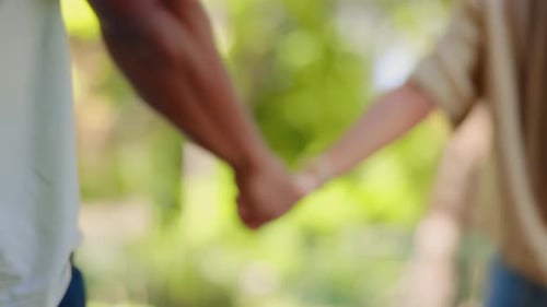 Back of happy couple, walking and holding hands in park for love, date and relax for freedom