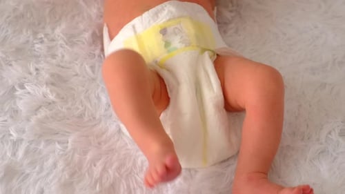 Baby Wearing Diaper Lying on White Fluffy Blanket