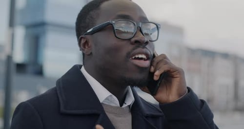 Young Adult Speaking on Smartphone Outside Office