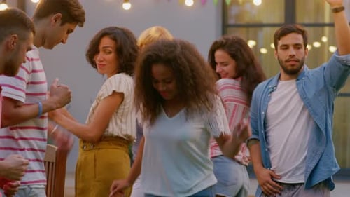 Group of Friends Dancing together at the Garden Party Celebration. Beautiful and Handsome People Ha