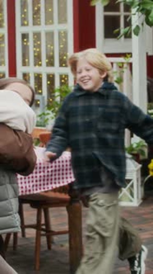 Vertical of Grandfather Embracing Grandchildren in Fall Garden Setting