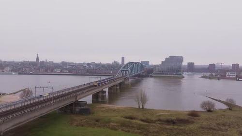 Train traffic near Nijmegen Central Station and railway bridge.