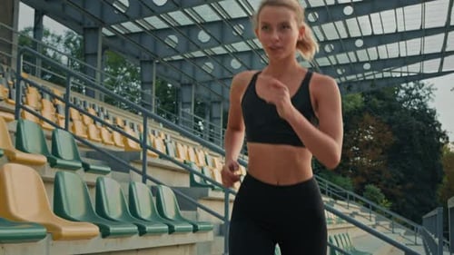 Sportswoman Runner Jogger Female Athlete Girl Fitness Woman Running on City Stadium Jogging Cardio