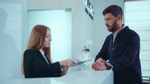 Attractive Young Man Fiil the Form at the Reception in Clinic Hospital Document Registration Medical