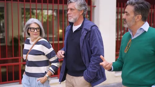 Stylish Senior Friends Walking and Talking Together Outdoors