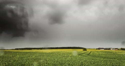 Lightning Strikes Under Stormy Sky In Rural Field Of Crops Time Lapse