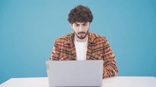 Young Adult Man Working on Laptop at Home