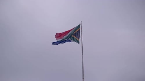 South African Flag Waving Against Overcast Sky