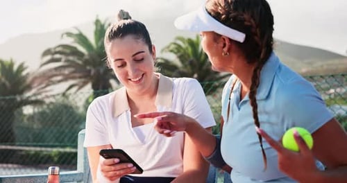 Tennis Friends chatting and using phone near court