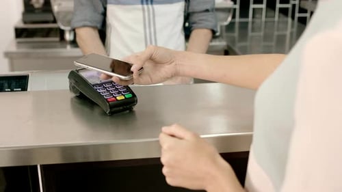 Business woman paying contactless in cafe