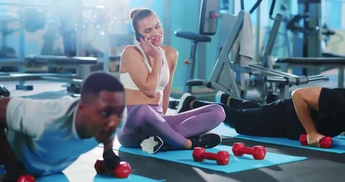 Engaging in an Intense Workout Session at the Gym with Various Dumbbells and Equipment