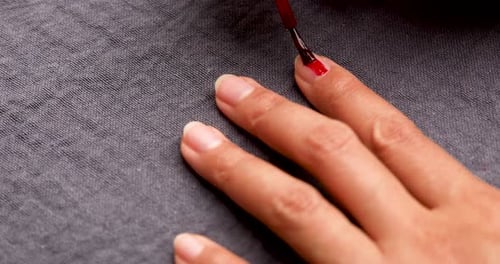 Red Nail Polish Applied to Fingers