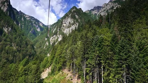 Majestic mountain peaks view. Lush green forest surrounds steep mountains under